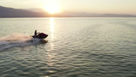 Woman-Riding-Extreme-Sports-Waverunner-Sea-Doo-Jet-Ski-on-Utah-Lake,-Aerial