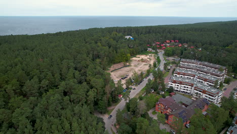 Aerial-view-of-Baltic-coastline-nestled-in-lush-green-trees-at-Stegna,Poland