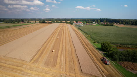 Vast-agriculture-land-with-harvesting-activity-by-tractor-in-progress