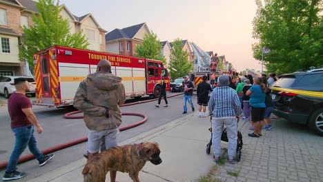 Crowds-slowly-dispersing-after-the-brigade-successfully-extinguished-a-suburban-fire