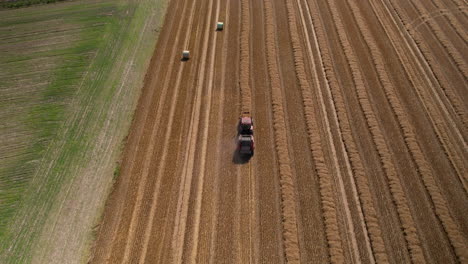 Beautiful-aerial-view-of-tractor-tilling-land-on-agriculture-farm-landscape