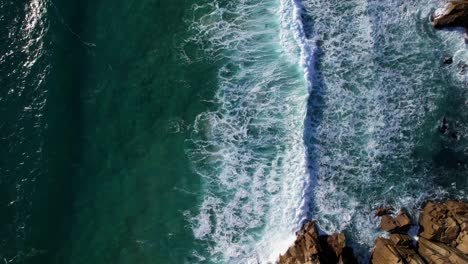 Ocean-Waves-Along-Cornish-Rocky-Coastline,-Top-Down-Aerial-View,-Cornwall,-UK
