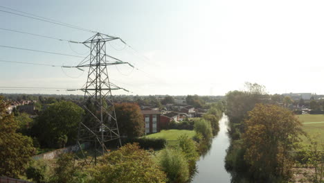 Descending-aerial-shot-of-suburban-electricity-pylon