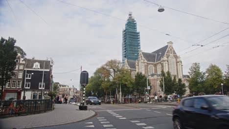 Street-view-of-Amsterdam-city-center-with-an-imposing-Westerkerk-in-the-background
