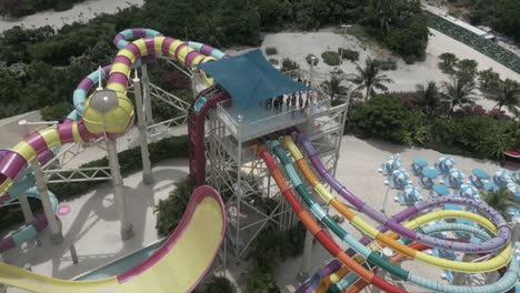 Aerial-view:-Tourists-at-top-of-tall-water-slide-tower-in-Bahamas