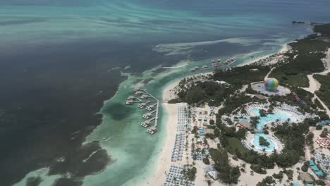 Flyover:-Thrill-Waterpark-and-tropical-cabanas-on-Coco-Cay,-Bahamas