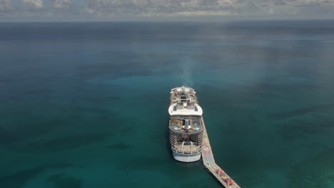 Aerial-orbits-stern-of-Royal-Caribbean-cruise-ship-at-Bahamas-pier
