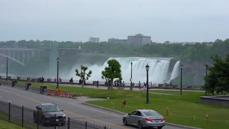 People-Walking-In-Front-Of-Niagara-Falls-In-Slow-Motion,-Canada-And-America-Boarder