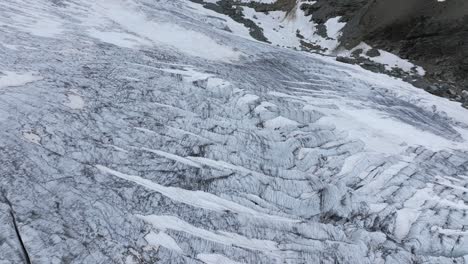 Drone-flying-over-surface-of-Fellaria-Glacier,-Valmalenco-in-Italy