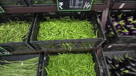 POV-shot,-woman-buying-fresh-guar-vegetables-from-super-market