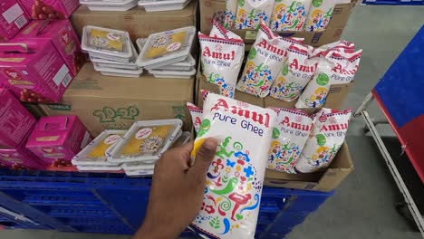 POV-shot,-a-woman-is-buying-Amul-pure-ghee-from-a-super-market-which-is-the-best-quality-for-health