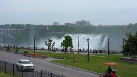 Cars-And-People-Passing-In-Front-Of-Niagara-Falls