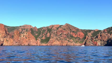 Scandola-nature-reserve-seen-from-tour-boat-in-summer-season,-Corsica-island-in-France