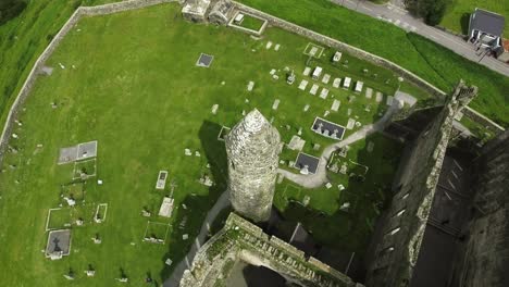 Aerial-drone-shot-of-castle-and-grassy-landscapes-in-Ireland
