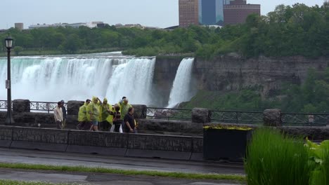 Group-Of-People-Visiting-Niagara-Falls,-Wearing-Ponchos