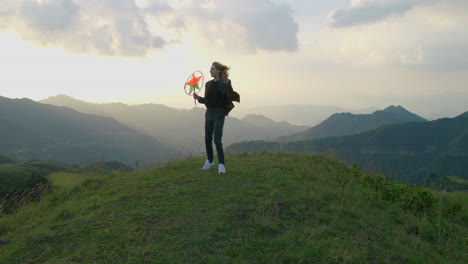 Slow-motion-shot-of-a-woman-posing-on-a-mountain-holding-a-star-lantern
