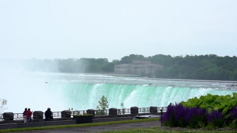 People-Walking-In-Front-Of-Niagara-Falls,-Travel-Destination-In-Canada