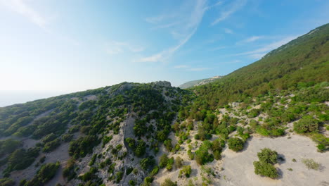 Sandy-shrubland-forest-ridgeline-and-stunning-blue-open-sky-and-ocean-of-Lubenice-Croatia