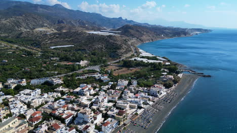 Drone-aerial-of-Beach-In-Crete,-Greece-at-city-Mirtos