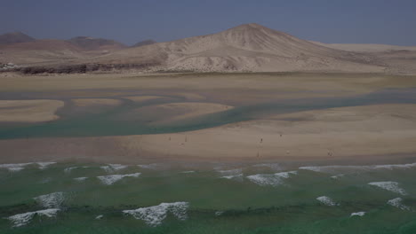 Sotavento-Beach,-Fuerteventura:-wonderful-aerial-view-in-orbit-of-the-fantastic-beach-on-a-sunny-and-hazy-day