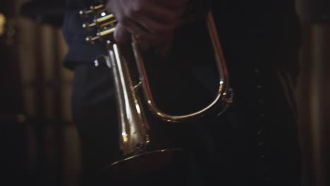 Mid-shot-of-person-snapping-fingers-to-beat-with-trumpet-in-hand