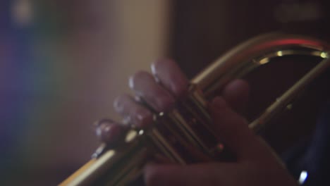 Close-up-shot-of-fingers-playing-a-trumpet-in-studio