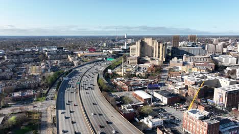 Cinematic-drone-shot-of-Downtown-Atlanta-busy-highway,-Skyline-buildings,-John-Lewis-Mural-wall,-and-historic-Butler-Street-YMCA,-Georgia,-USA