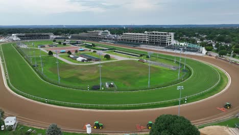 Aerial-shot-of-tractors-preparing-dirt-at-Kentucky-Derby,-Churchill-Downs-horse-race-track