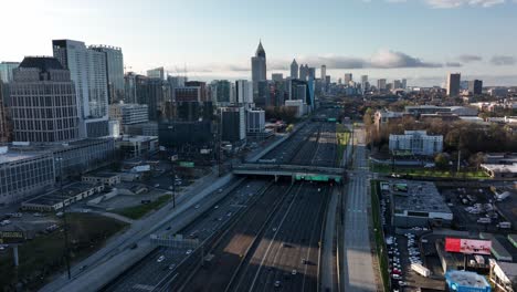 Aerial-view-of-moving-traffic-on-the-metropolitan-highway,-Downtown-Atlanta-famous-skyscrapers,-Skyline-buildings,-Georgia,-USA