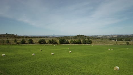 Drone-shot-of-farmland-with-hay-bales