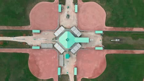 Overhead-Top-Down-Drone-Aerial-View-of-Massive-Baseball-Softball-Diamond-Recreational-Facility-in-the-Summer-Green-Grass-Tournament-Play
