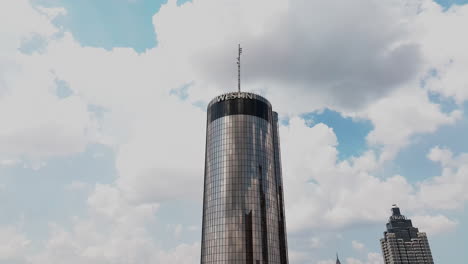 Aerial-ascending-footage-of-futuristic-round-tower-with-mirroring-surface
