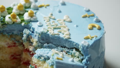 Slicing-a-fluffily-layered-cake,-filled-with-decadent-strawberry-filling,-topped-with-a-deliciously-soft,-sweet,-and-delectable-blue-buttercream-frosting