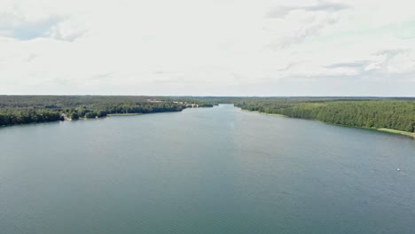 High-altitude-flyover-of-Lake-Jezioro-Gwiazdy-in-Borowy-Młyn-in-Kaszuby,-Pomeranian-Voivodeship,-Poland