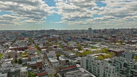 Aerial-flyover-american-neighborhood-in-New-York-during-sunny-day-with-clouds-at-blue-sky---Establishing-drone-shot