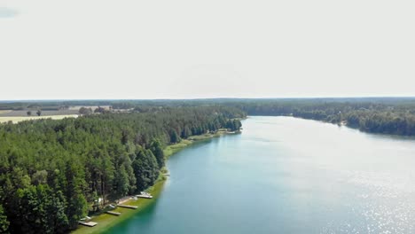 Drone-aerial-view-of-High-altitude-flyover-of-Lake-Jezioro-Gwiazdy-in-Borowy-Młyn,-Pomeranian-Voivodeship,-Poland