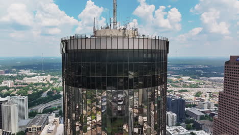 Orbit-shot-around-top-of-high-rise-downtown-building-in-metropolis
