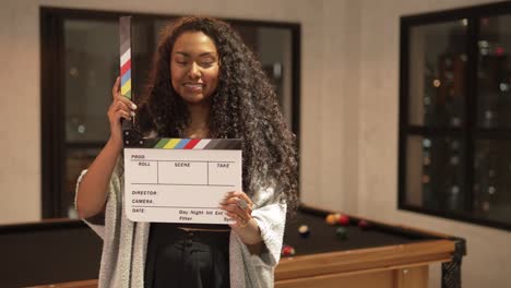 beautiful-young-black-woman-happy-smiling-clapperboard-cinema-home