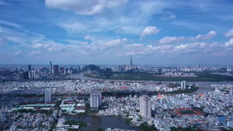 Ho-Chi-Minh-City-drone-crane-shot-ascending-on-sunny-day-with-blue-sky-and-moving-clouds