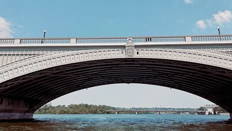 Arlington-Memorial-Bridge-view-from-Potomac-river-boat-view-with-airplane-flyby-in-the-sky-in-Washington-D
