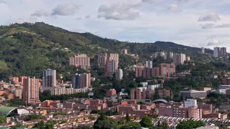 Skyscrapers-built-on-the-mountain-in-city-Medellin,-Colombia,-aerial-slider