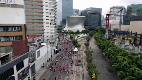 frontal-drone-shot-of-maraton-de-la-ciudad-de-mexico-near-museo-soumaya
