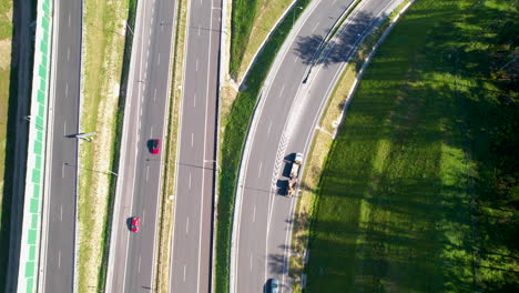 Aerial-top-down---shot-from-above-a-multi-lane-expressway---cars-diverging-in-multiple-directions---land-transport-and-communication
