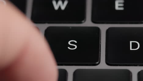 Close-up-Macro-Shot-Of-A-Man-Typing-On-A-Laptop-Keyboard-With-a-Focus-On-The-S-Key