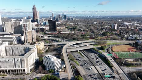 Panoramic-view-of-Downtown-Atlanta-Interstate-highway-junction-traffic,-Overpass-with-modern-cityscape,-Aerial