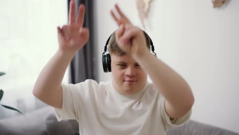 A-guy-with-down-syndrome-having-great-time-on-the-living-room-at-home-listening-music