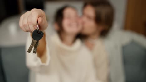 Blurred-footage-couple-in-living-room-show-keys-from-first-house