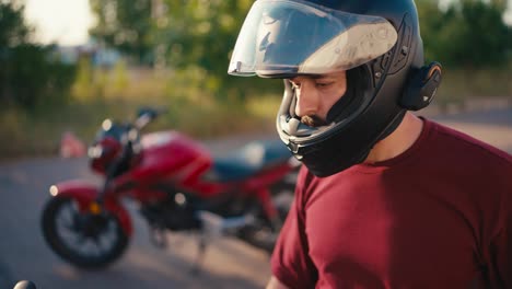 Close-up-shot-of-a-helmeted-motorcyclist-communicating-with-another-motorcyclist-using-helmeted-headphones.-Moped-riding-experts-communicate