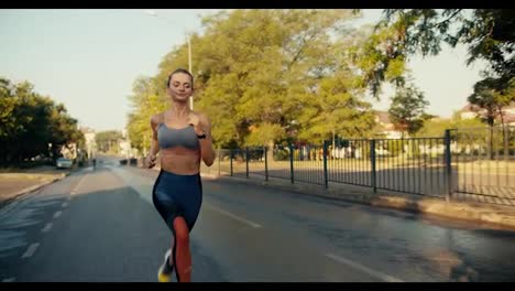 Overview-of-a-fit-girl-in-a-sports-uniform-who-is-jogging-along-the-road-in-the-morning.-Outdoor-sports