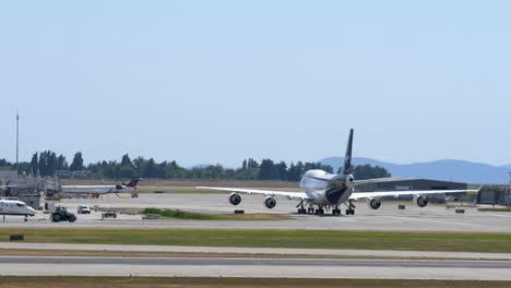 Eine-Boeing-747-Der-Lufthansa-Rollt-Zum-Gate-Und-Das-Flugzeug-Wird-Abgeschleppt
